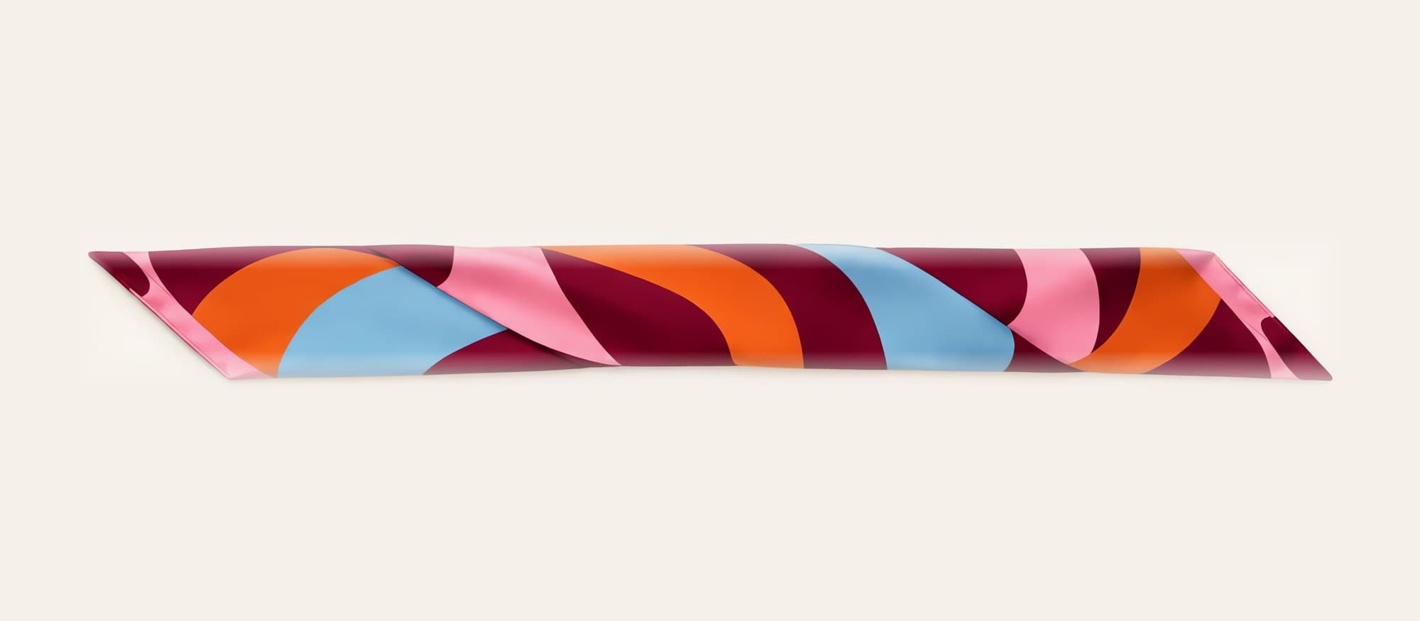 The Coil silk scarf, rolled into a band
